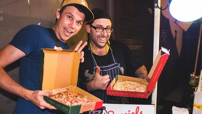 Luke Soanes (left) and owner Craig Mawhinney enjoy a pizza from the Back Dock Pizzaria.