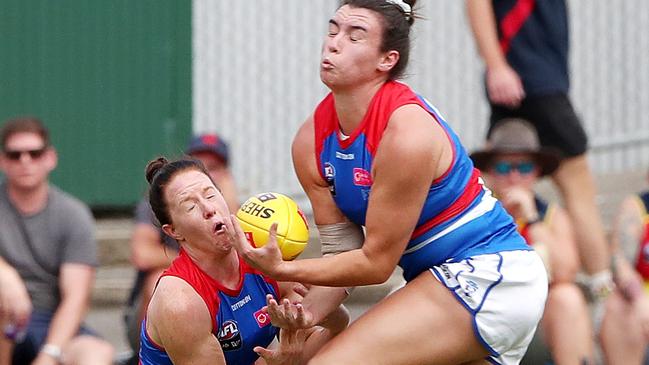 Brooke Lochland gets cleaned up by teammate Bonnie Toogood. Picture: AFL Photos via Getty Images