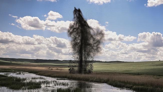 A mortar explodes next to the road leading to the city of Lysychansk in the eastern Ukranian region of Donbas. Picture: AFP