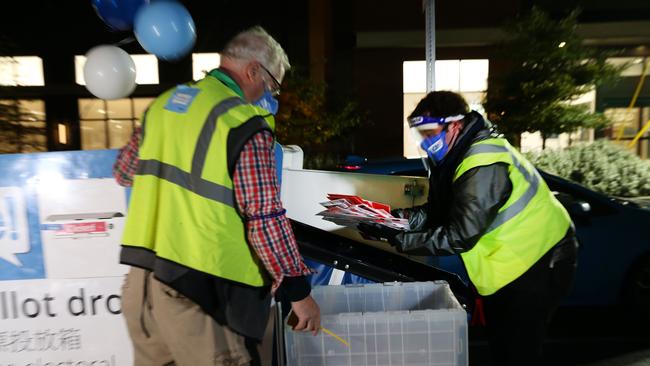 Elections workers empty a ballot drop box in Seattle. Picture: Getty Images/AFP