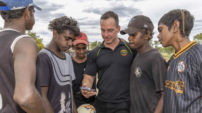 Alice Springs based Yipirinya School principal Gavin Morris with students on the school grounds.