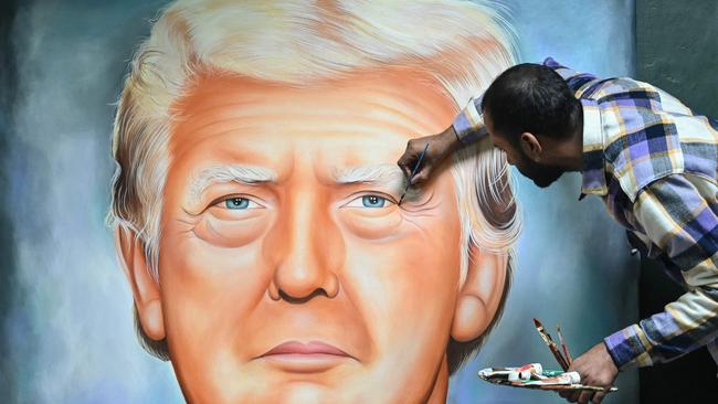 An artist gives final touches to a painting of US President-elect Donald Trump in Amritsar, in India's state of Punjab, on January 19, 2025. Picture: Narinder NANU / AFP