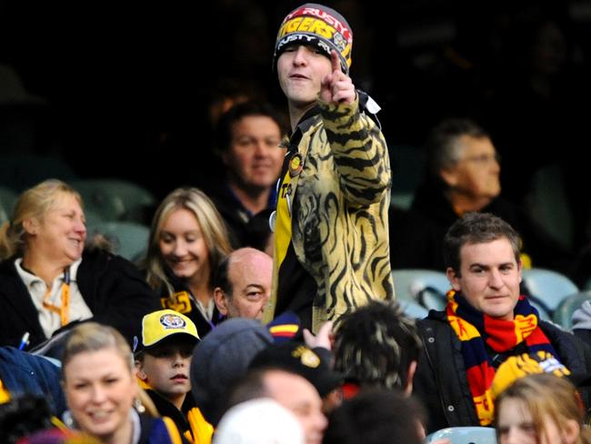 An angry Tigers supporter fires one last shot at a Crows fan on his way out of the G.