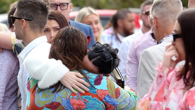 Family and friends gathered at the funeral of Olyvia Cowley on the Gold Coast - her mother (in white) hugs a friend. Picture: NCA NewsWire/ Richard Gosling