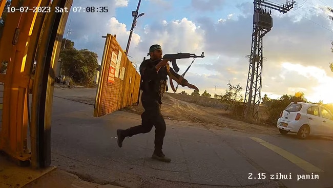 An armed man runs aiming his gun during the October 7 attack by Hamas, in this screen grab from footage captured by a surveillance camera in Kibbutz Alumim, Israel, and released November 20, 2023. Photo: @Israel / X