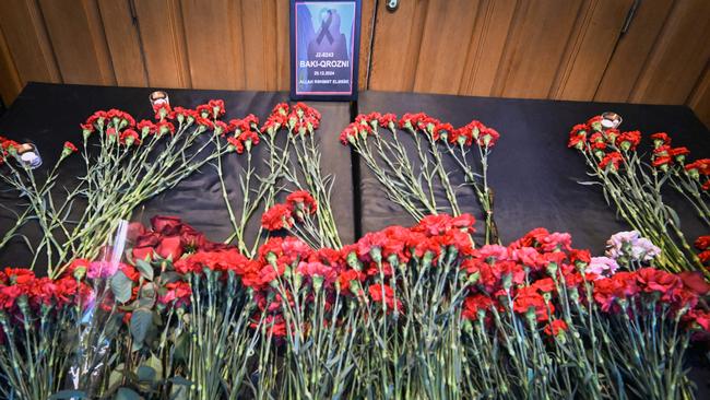 Flowers are seen left at the stairs of Azerbaijan's Embassy in Moscow on December 26, 2024 as tribute to the victims of Azerbaijan Airlines' plane crash. (Photo by Alexander NEMENOV / AFP)