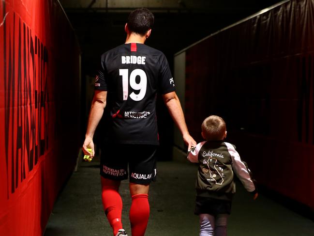 Mark Bridge returns to the dressing room with his son after his last game for the Wanderers. Picture: Getty Images 