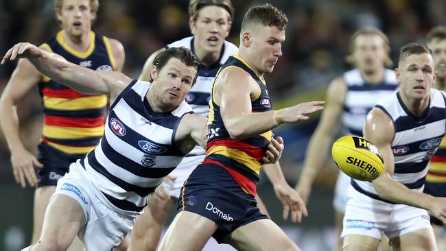 Rory Laird gets his kick away in front of Patrick Dangerfield. Picture: Sarah Reed