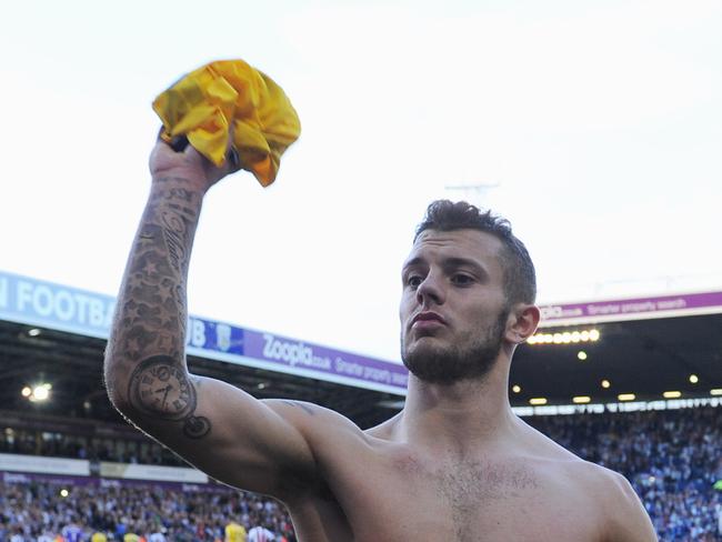 WEST BROMWICH, ENGLAND - OCTOBER 06: Goal scorer Jack Wilshere of Arsenal throws his shirt in to the crowd after the Barclays Premier League match between West Bromwich Albion and Arsenal at The Hawthorns on October 6, 2013 in West Bromwich, England. (Photo by Michael Regan/Getty Images)