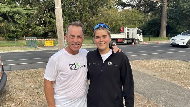 North Melbourne and AFL premiership coach Alistair Clarkson with Delaney Troon who is running 21 half marathons in 21 days. Picture: Shane Jones.