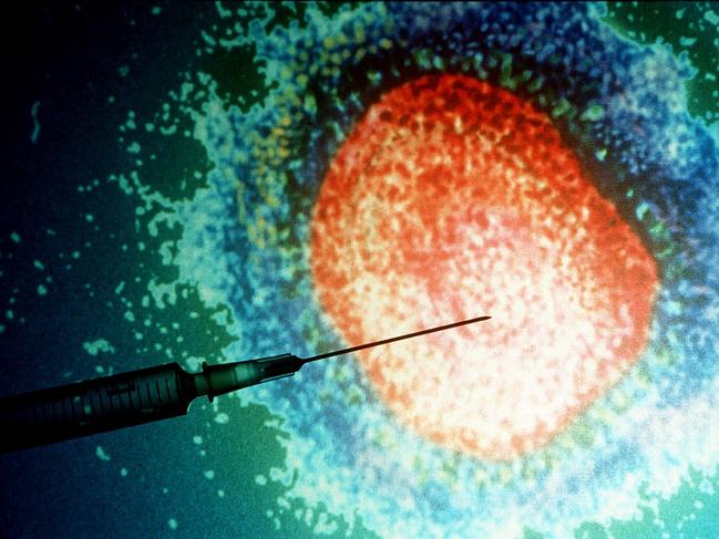 Hypodermic syringe in front of magnified influenza ( flu ) virus.  Generic Medical diseases needle