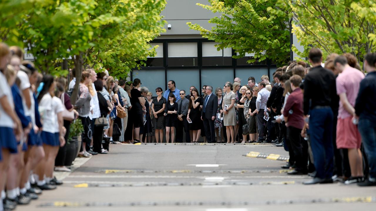 Mourners form a guard of honour as the hearse leaves the memorial service for Whakaari/White Island volcano victims Anthony, Elizabeth and Winona Langford at Maris College North Shore Auditorium in Sydney, Monday, December 30, 2019. Picture: Bianca De Marchi/AAP