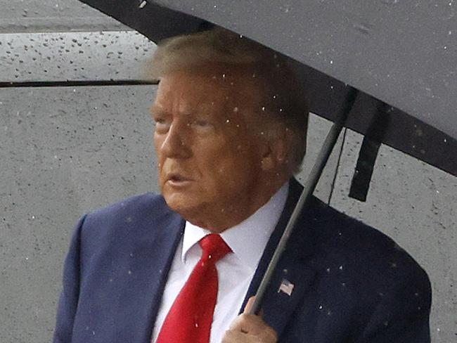 ARLINGTON, VIRGINIA - AUGUST 03: Former U.S. President Donald Trump holds an umbrella as he arrives at Reagan National Airport following an arraignment in a Washington, D.C. court on August 3, 2023 in Arlington, Virginia. Former U.S. President Donald Trump pleaded not guilty to four felony criminal charges during his arraignment this afternoon after being indicted for his alleged efforts to overturn the 2020 election.   Tasos Katopodis/Getty Images/AFP (Photo by TASOS KATOPODIS / GETTY IMAGES NORTH AMERICA / Getty Images via AFP)