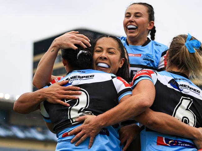 SYDNEY, AUSTRALIA - JULY 27: Cassie Staples of the Sharks (2) celebrates scoring a try with team mates during the round one NRLW match between Cronulla Sharks and North Queensland Cowboys at PointsBet Stadium on July 27, 2024 in Sydney, Australia. (Photo by Mark Evans/Getty Images)