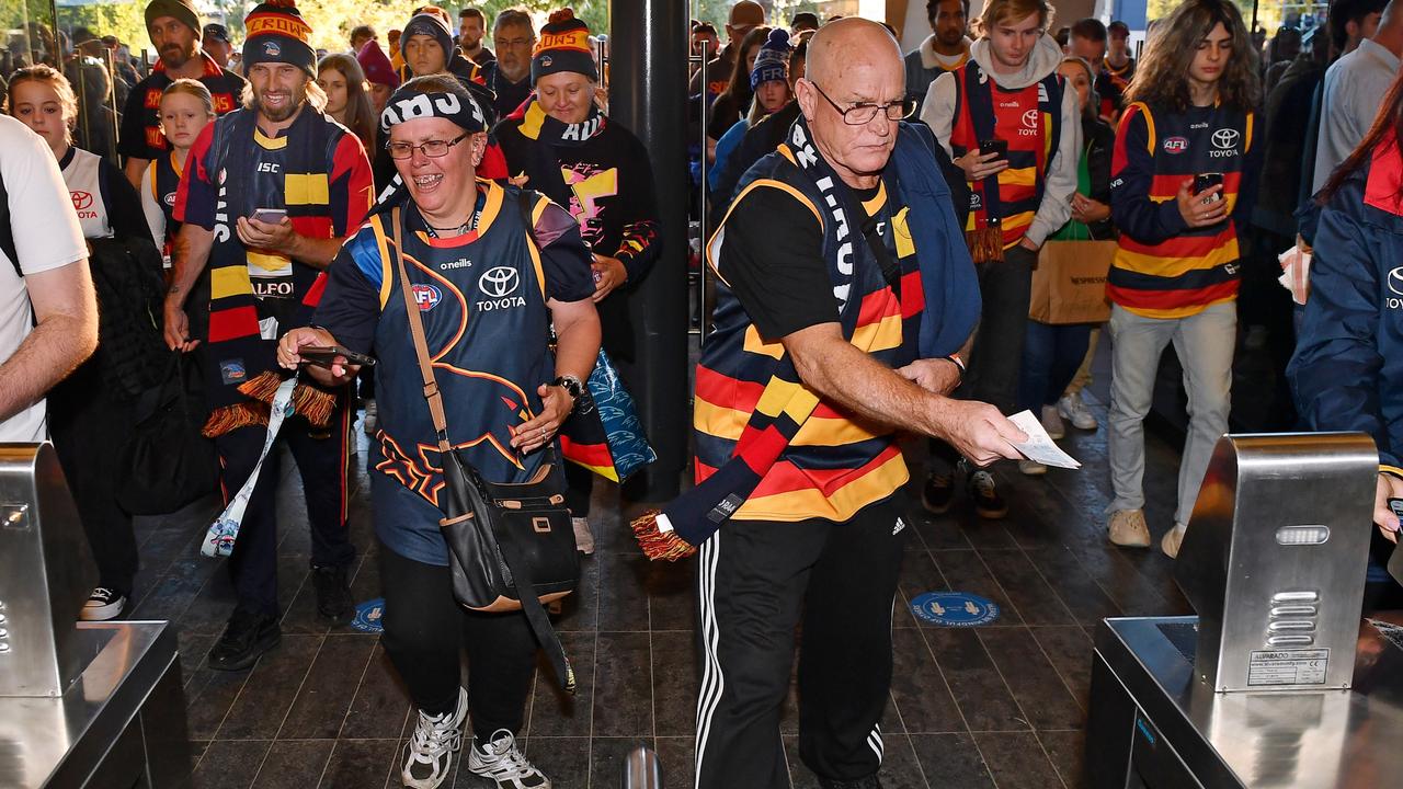 The first Gather round Crows fans scan in through the Southern gates at Adelaide Oval. Picture: Mark Brake