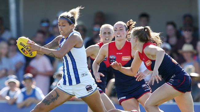 North Melbourne’s Mo Hope skips away from her Demons opponents. Picture: Michael Klein