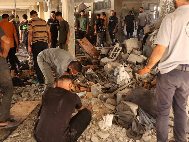 Palestinians inspect the damage at the site of an Israeli strike on a school housing displaced Palestinians in Gaza City's Zaytoun neighbourhood on September 21. Picture: Omar Al-Qattaa/AFP