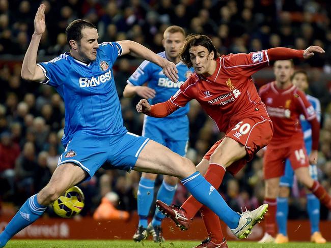 John O'Shea charges down Lazar Markovic’s shot.