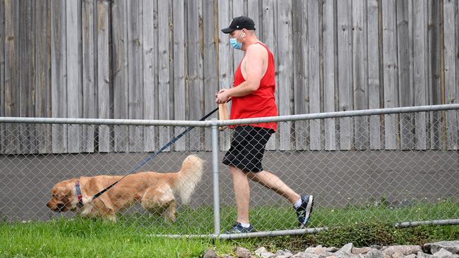 A man wears a face mask on a morning walk in the suburb of Greenslopes during the first day of COVID-19 lockdown in Brisbane. Picture: Dan Peled