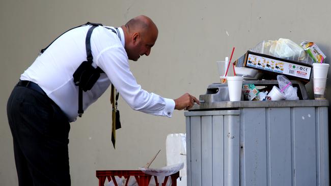 Detectives hunt for evidence following the shooting. Picture: John Grainger