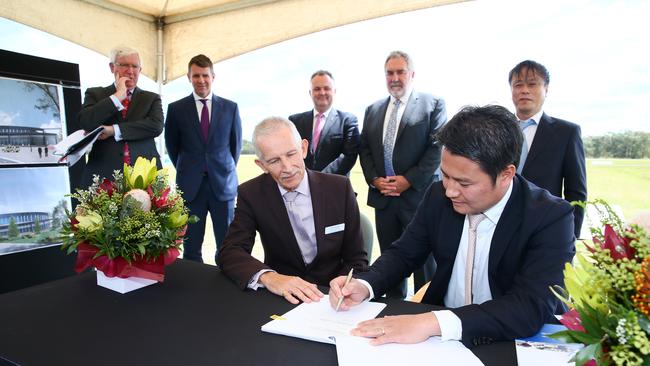 Khoa Hoang, Amphibian Aircraft Group President, (right), signs an agreement with Rob Noble, Central Coast Council CEO, after the announcement of a new aircraft facility, Amphibian Aerospace Industries is to relocate its offshore manufacturing to the Central Coast. Picture: Peter Clark