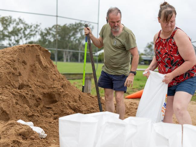 Lismore on Thursday: Val Riley and Tony Edwards of East Lismore fill sandbags at the Nesbit Park filling stations to protect their home from excess rainwater run-off. Picture: David Freund