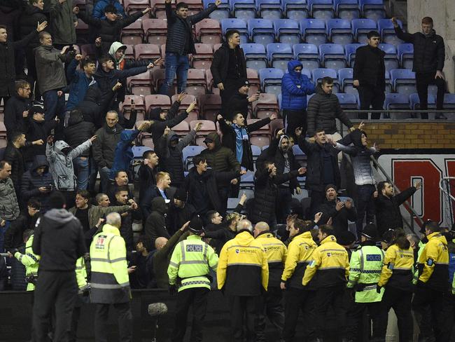 Supporters react after the English FA Cup fifth round football match between Wigan Athletic and Manchester City.