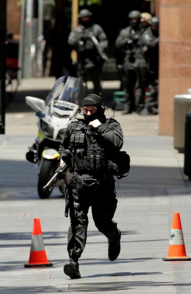 An armed policeman is seen on Philip St running from Martin Place on December 15, 2014. Picture: Mark Metcalfe / Getty