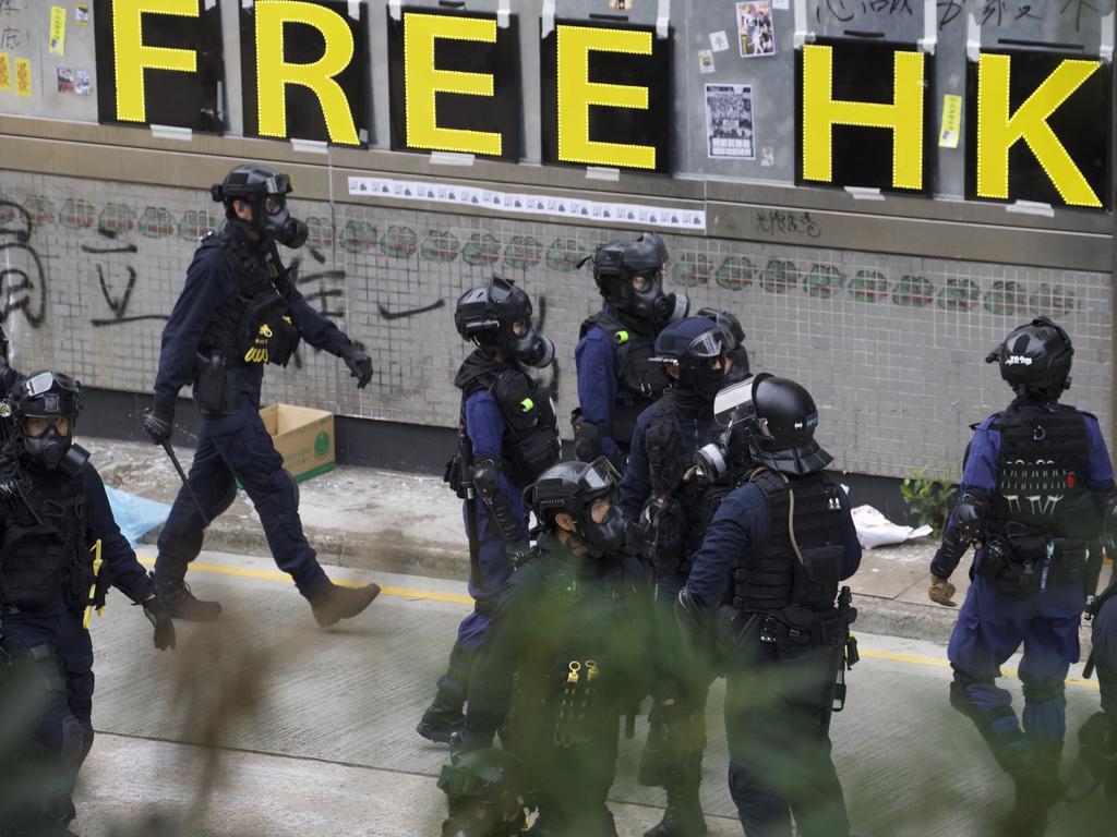 Police chase away protesters calling for electoral reforms and a boycott of the Chinese Communist Party in Hong Kong during new protests. Picture: AP Photo/Ng Han Guan