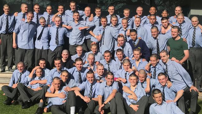 Sturt’s Tom Emmett (at back, sixth from right) with his Pembroke schoolmates after they shaved their heads to raise money for the Michael Rice Centre in support of his battle with cancer. Picture: Supplied.