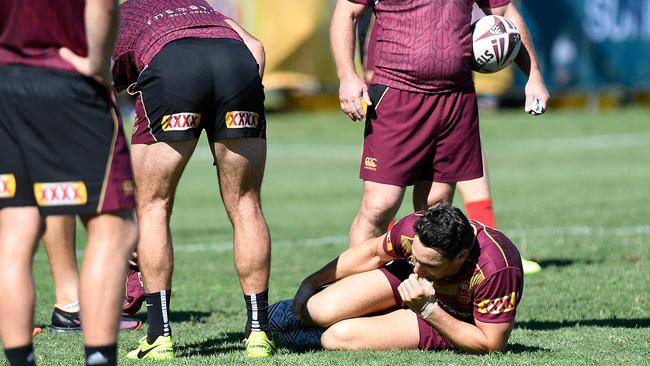 Billy Slater goes down injured during a Queensland Maroons State of Origin training session at Sanctuary Cove on Sunday.