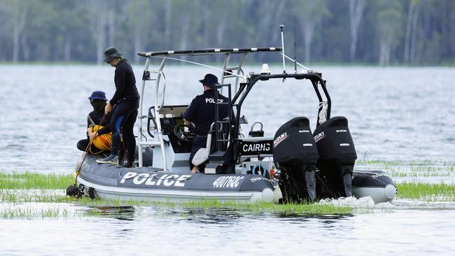 Police divers, SES and Queensland Fire and Emergency Services personnel search the waters off the Lake Tinaroo boat ramp for the body of a 49 year old Atherton man, who drowned while swimming in the lake on Sunday with his two children. Photo: Brendan Radke