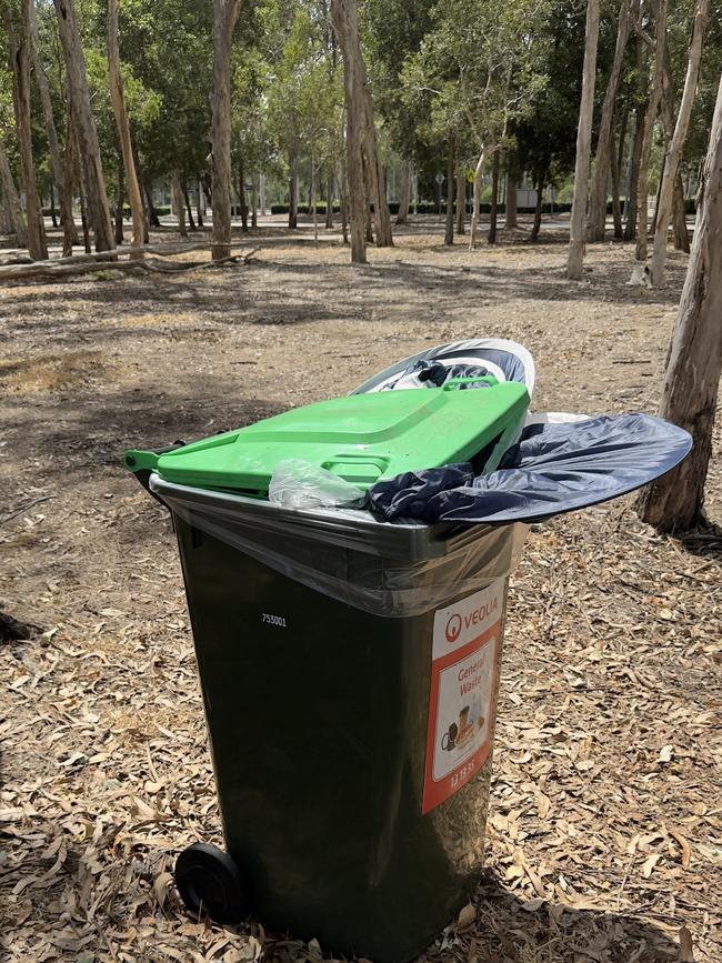 A discarded tent in a bin outside the main entrance of the Brisbane Entertainment Centre.