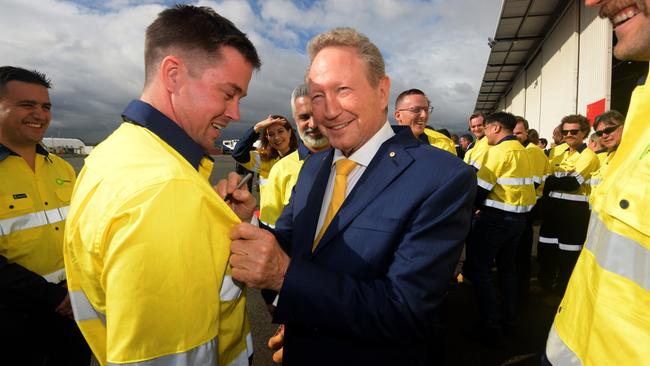 Andrew Forrest signing a workers shirt as he meets Fortescue employees.