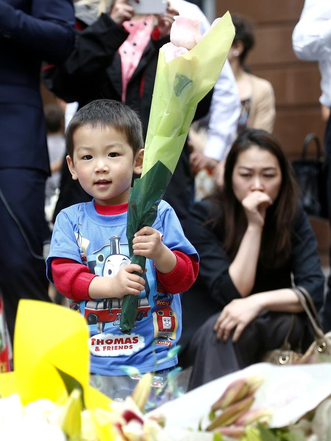 Eason Chen, 2, visits the memorial. Picture: Bradley Hunter