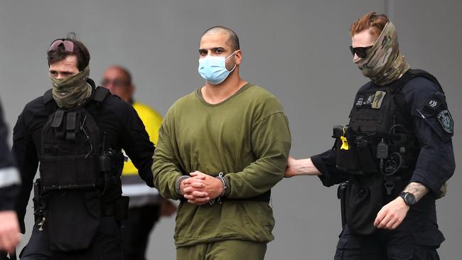 Alleged drug smuggler Mostafa Baluch is escorted to a NSW police plane at Coolangatta Airport as he is extradited from Queensland. Picture: Dan Peled