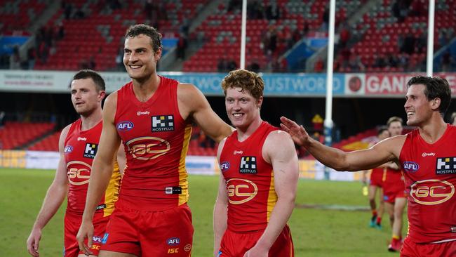 Matthew Rowell of the Suns (centre) is seen following the Round 4 AFL match between the Gold Coast Suns and the Fremantle Dockers at Metricon Stadium. (AAP Image/Dave Hunt)