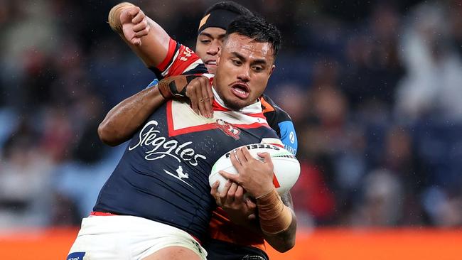 SYDNEY, AUSTRALIA - JUNE 30: Spencer Leniu of the Roosters is tackled by the Tigers defence during the round 17 NRL match between Sydney Roosters and Wests Tigers at Allianz Stadium, on June 30, 2024, in Sydney, Australia. (Photo by Brendon Thorne/Getty Images)