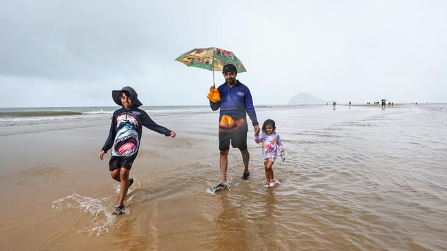 Alexander John, 10, Josu John, and Emma Josu, 3, enjoying walking along the sand in the middle of the ocean, which only happens a few times a year. Picture: Brendan Radke