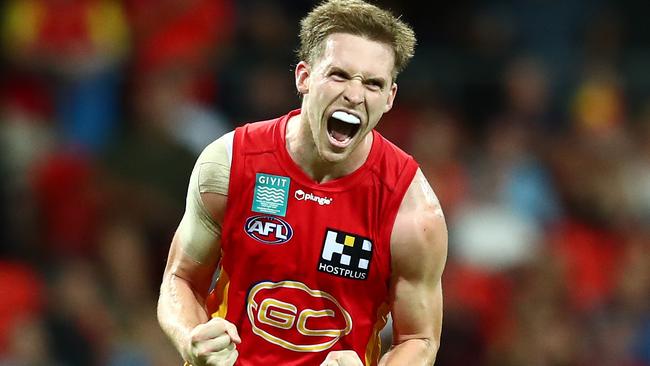 Noah Anderson celebrates an important goal at Metricon Stadium. Picture: Getty Images