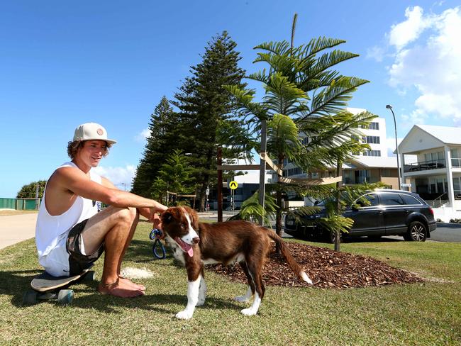 Cory White and his puppy Bear near the newly planted trees. Photo: David Clark