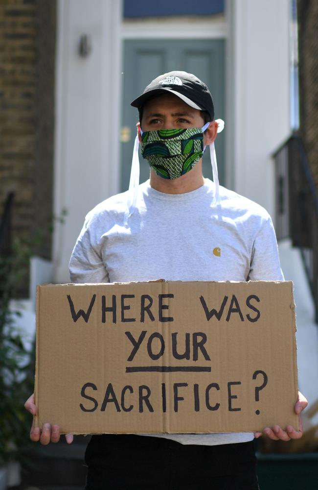 A demonstrator displays a homemade placard that reads "Where was your sacrifice" outside the home of 10 Downing Street special advisor Dominic Cummings. Picture: DANIEL LEAL-OLIVAS / AFP.