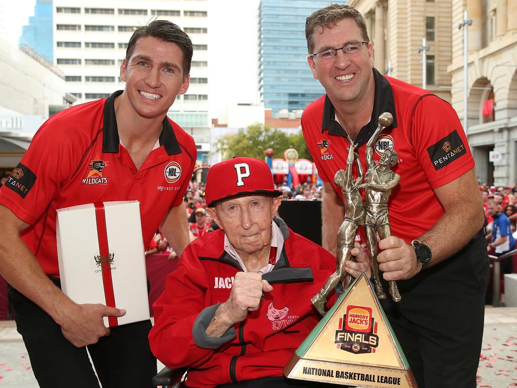 Damian Martin, Jack Bendat and Trevor Gleeson pose with the 2018/19 NBL Championship trophy and fans after winning their ninth NBL championship. Photo: Paul Kane/Getty Images.