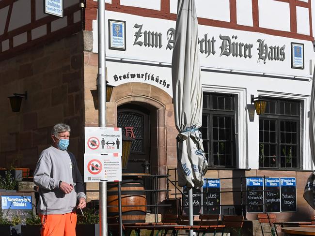 A city employee sets up an information board detailing new coronavirus restrictions in the city of Nuremberg, southern Germany. Picture: AFP