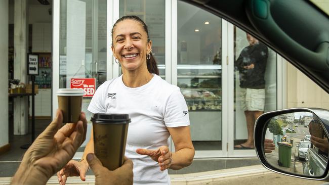 Annie Karam, part owner of Speedos cafe at Bondi Beach delivers coffee as part of a take away service. Picture: Jenny Evans