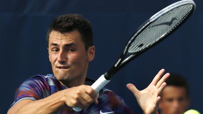 Bernard Tomic is out of the US Open after a four-set defeat.