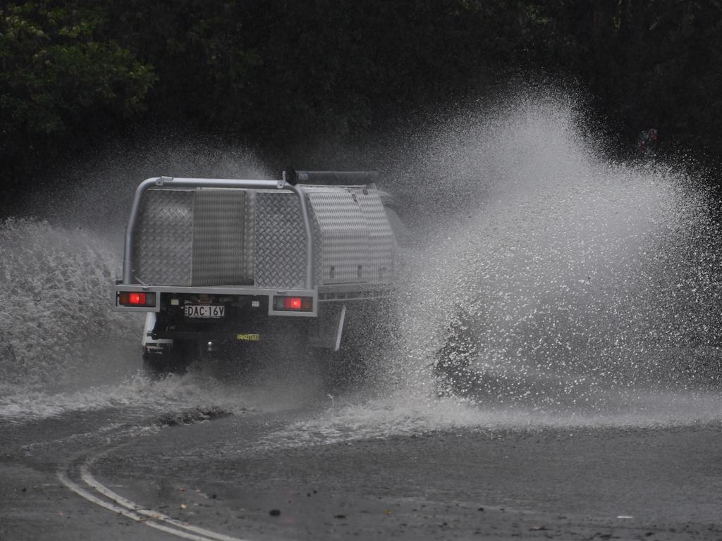 A car drives through floodwaters on Railway Terrace in Lewisham during wild weather in Sydney, Wednesday, November 28, 2018. Sydney received more than a month's worth of rain in just two hours - with Observatory Hill recording 84.6mm by 7am. The November average is 83.8mm. (AAP Image/Dean Lewins) NO ARCHIVING