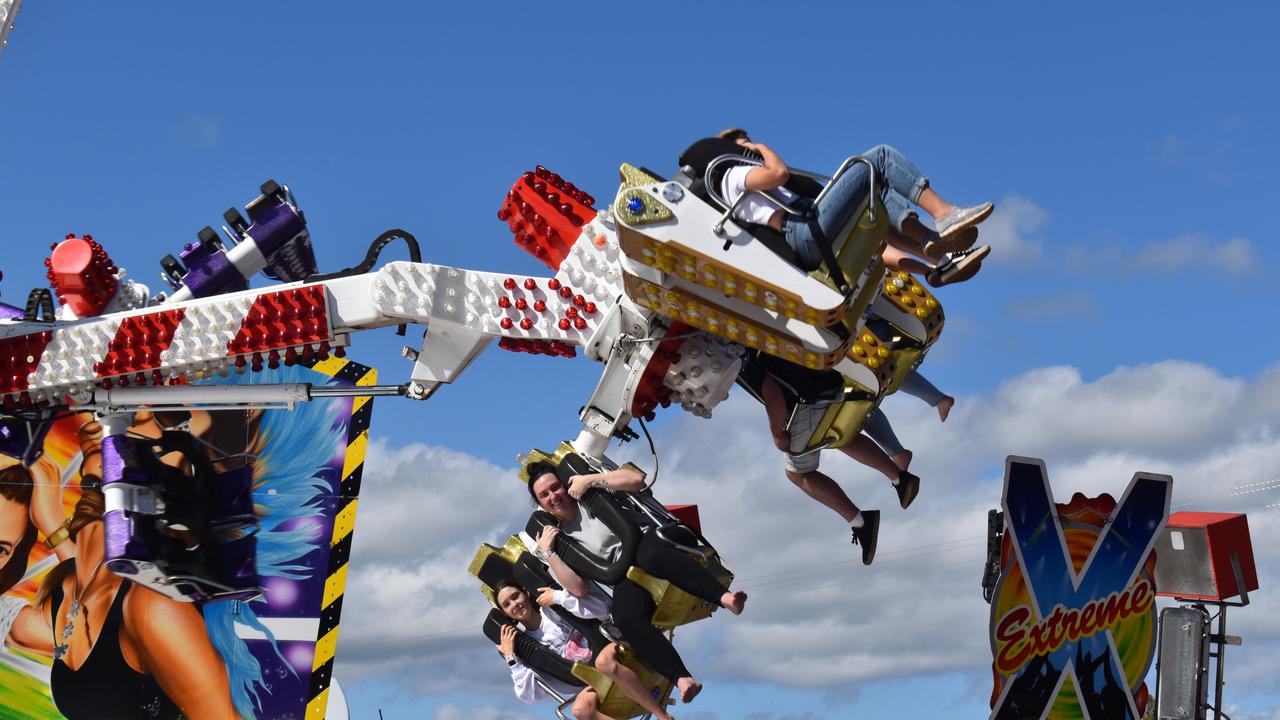 Fraser Coast Ag Show patrons fly through the air on rides. Photo: Stuart Fast