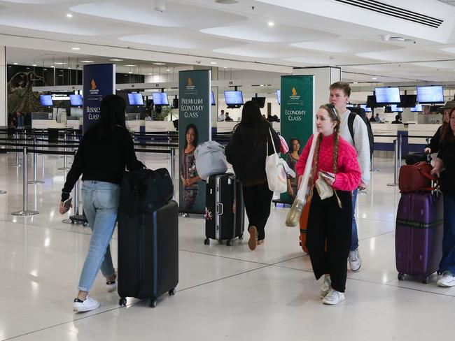 SYDNEY, AUSTRALIA - NewsWire Photos - MAY 22, 2024: A general view of people  walking past the Singapore Airlines check in counters at Sydney International Airport today after the Singapore Airlines London to Sydney flight suffered major turbulence causing the death of one man and injuries to dozens of passengers. Picture: NewsWire / Gaye Gerard