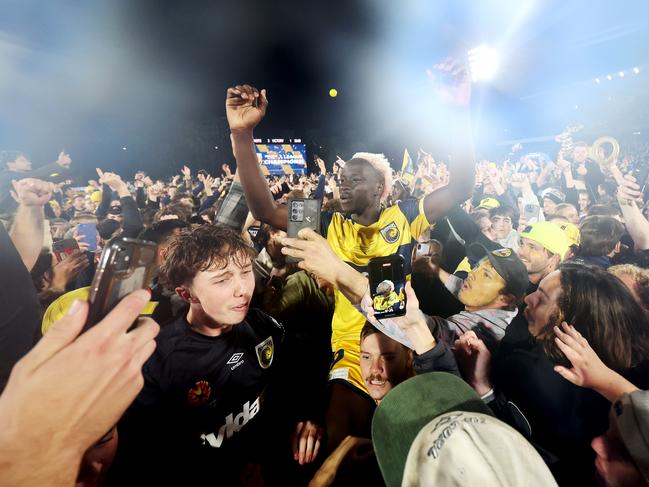 GOSFORD, AUSTRALIA - MAY 25: Alou Kuol of the Central Coast Mariners celebrates winning with fans after the A-League Men Grand Final match between Central Coast Mariners and Melbourne Victory at Industree Group Stadium on May 25, 2024, in Gosford, Australia. (Photo by Mark Metcalfe/Getty Images)